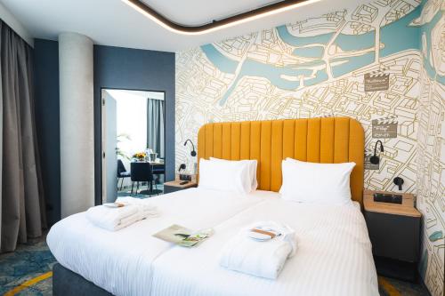 a hotel room with a bed with towels on it at Focus Hotel Premium Wrocław in Wrocław