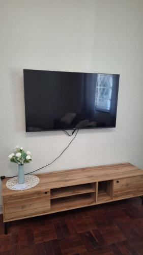 a flat screen tv hanging on a wall at 21 on Main in Benoni