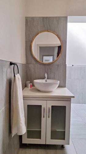 a bathroom with a sink and a mirror at 21 on Main in Benoni