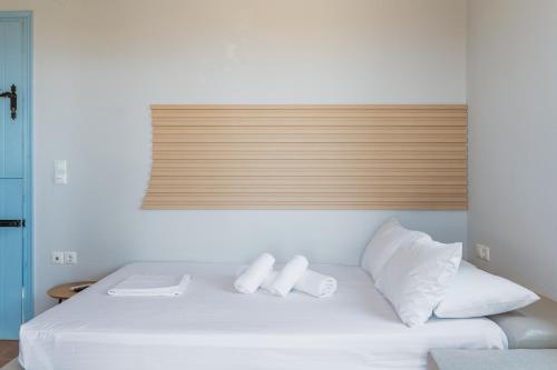 a white bed with two white pillows on it at La Casa Tinos 22 in Agios Ioannis Tinos
