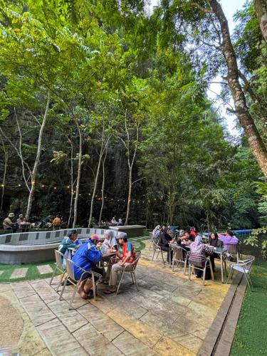 a group of people sitting in chairs in a park at Xscape Tambun in Ipoh