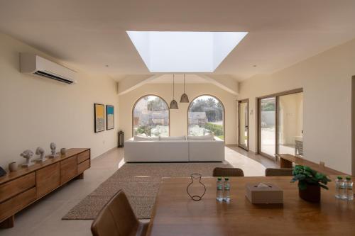 a large living room with a large skylight at Ivory House Resort - Ophiolite in Hatta