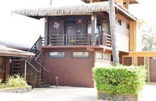 a house with a balcony and a staircase at Nilaveli Beach Resort - Level 1 Certified in Nilaveli
