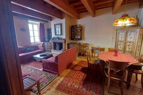 a living room with a couch and a table at Apartment with fireplace in the city center in Briançon