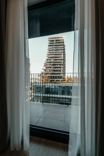 a view of a tall building from a window at BW Cityline Residences in Belgrade