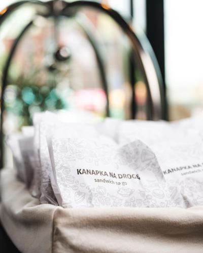 a close up of a bed with white sheets at Focus Hotel Premium Wrocław in Wrocław