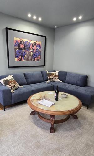 a living room with a blue couch and a coffee table at Maruja Rural 2 in Sober