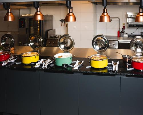 a kitchen with pots and pans on a counter at Focus Hotel Premium Wrocław in Wrocław