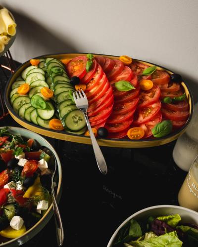 a table topped with two plates of food with vegetables at Focus Hotel Premium Wrocław in Wrocław