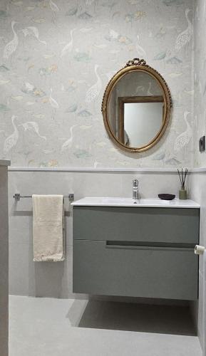 a bathroom with a sink and a mirror at Maruja Rural 2 in Sober