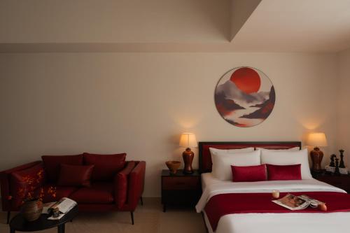 a bedroom with a bed and a red couch at DingD0ng Suites - The Sun Avenue - Free Pool & Gym in Ho Chi Minh City