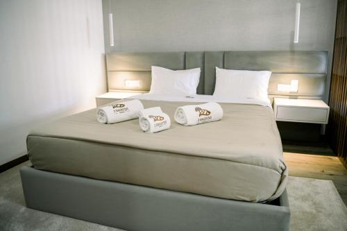 a large bed with two pillows on top of it at 3Encostas in Cabeceiras de Basto
