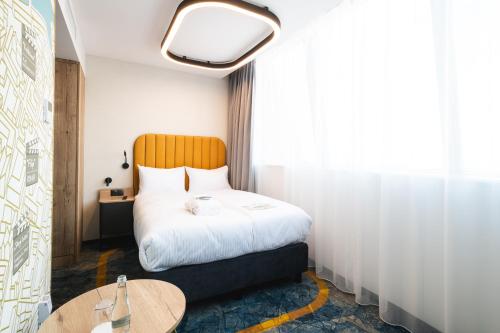 a hotel room with a bed and a table at Focus Hotel Premium Wrocław in Wrocław