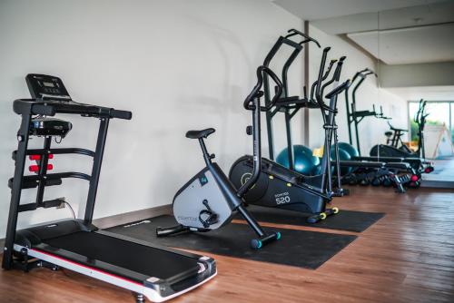 a gym with several exercise bikes and a treadmill at Sea Theatre Kata by ROI in Ban Nong Chaeng
