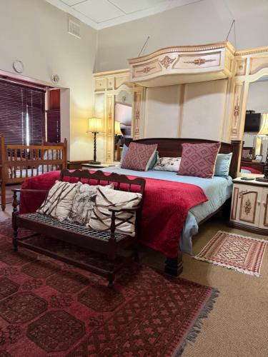 a bedroom with a large bed with a canopy at Bleu Bird Guesthouse in Durban