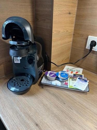 a coffee maker sitting on a counter next to a plate at FeWo mit Alpaka Blick in Bad Gandersheim
