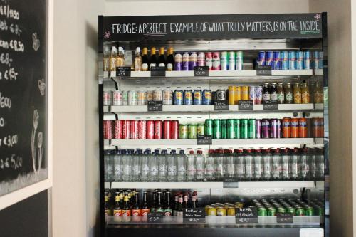 a display case in a store filled with drinks at Holiday Inn - the niu, Dairy Haarlem in Haarlem