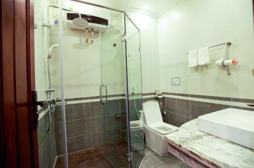 a bathroom with a shower and a toilet and a sink at Cao Nguyên 2 Villa Hà Giang in Ha Giang