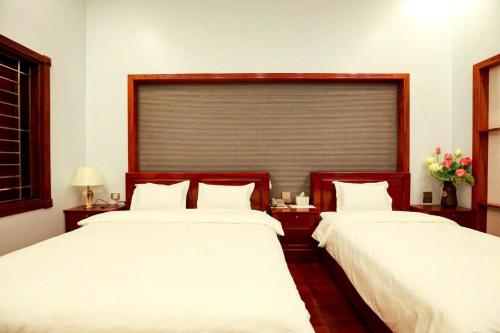 two beds sitting next to each other in a bedroom at Cao Nguyên 2 Villa Hà Giang in Ha Giang