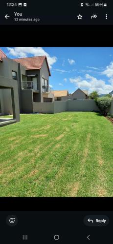 a picture of a house with a yard at Mountain view in Hartbeespoort