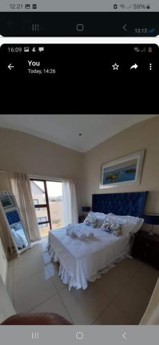 a picture of a bedroom with a bed and a window at Mountain view in Hartbeespoort