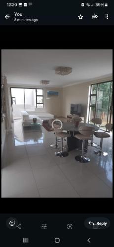 a view of a living room with a table and chairs at Mountain view in Hartbeespoort