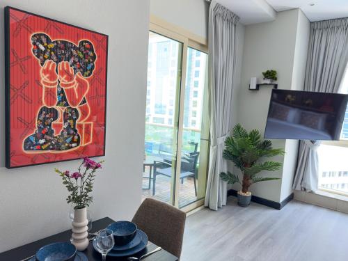 a living room with a red painting on the wall at Stylish Studio Apartment with large Balcony and Sea Views, free Parking, Dubai Marina - JBR in Dubai