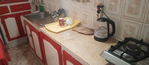 a kitchen with a sink and a counter top at Chambre privée avec terrasse in Tunis