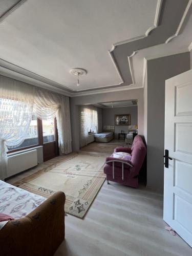 a living room with a bed and a couch at Begonvil Butik Apart in Eceabat