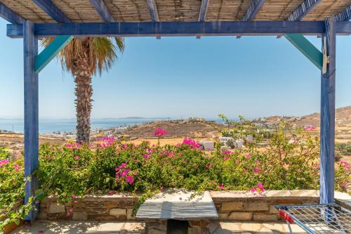a view from the porch of a house with flowers at La Casa Tinos 22 in Agios Ioannis Tinos
