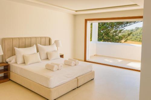 a bedroom with a bed with a large window at Villa Jasmin 12 in M'diq