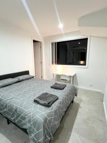 a bedroom with a large bed and a large window at Queen Room with Attached Bathroom - OR10 in Guildford