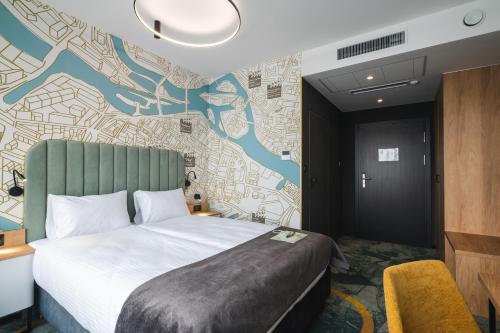 a hotel room with a bed and a wall mural at Focus Hotel Premium Wrocław in Wrocław