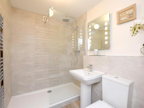 a bathroom with a sink and a toilet and a shower at 1 Bed in Hawkshead Village LLH16 in Hawkshead