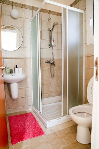 a bathroom with a shower and a toilet and a sink at Agesilaos Seaview 33 in Ayia Napa