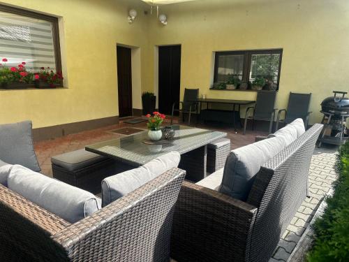 a patio with wicker furniture and a table and chairs at Apartmany U Stareho Labe in Nymburk