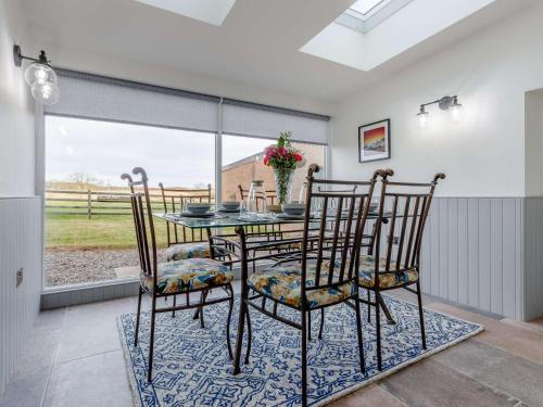 a dining room with a glass table and chairs at 5 Bed in Anstruther 83504 in Pittenweem