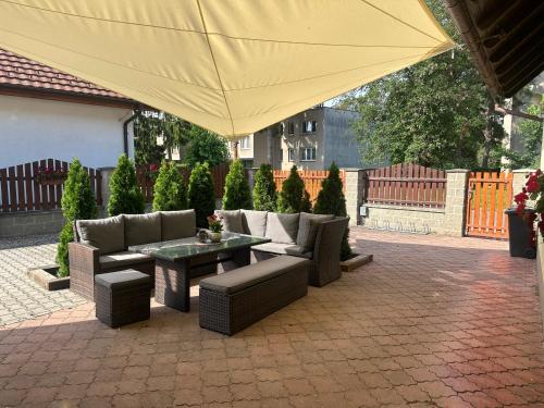 a patio with a table and chairs and a yellow umbrella at Apartmany U Stareho Labe in Nymburk