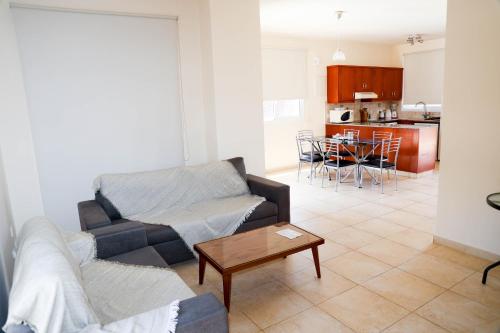 a living room with a couch and a table at Agesilaos Seaview 33 in Ayia Napa
