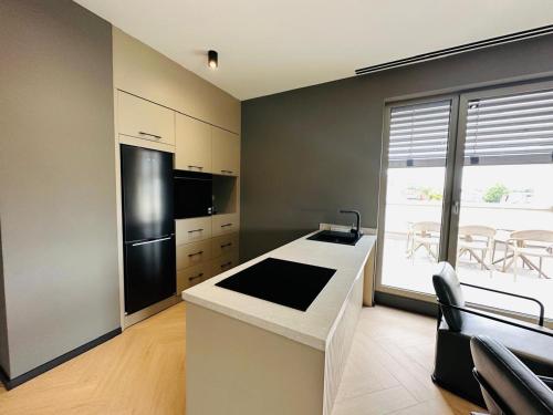 a kitchen with a black refrigerator and a counter at Taunus Suites in Oberursel