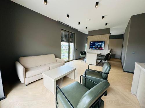a living room with a couch and a table at Taunus Suites in Oberursel