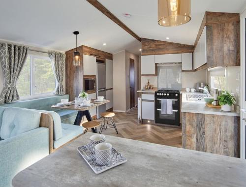 a kitchen and living room with a couch and a table at Billing Aquadrome Holiday Park in Great Billing