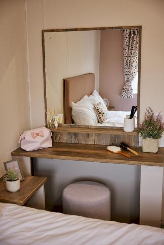 a mirror on a shelf above a bed at Billing Aquadrome Holiday Park in Great Billing
