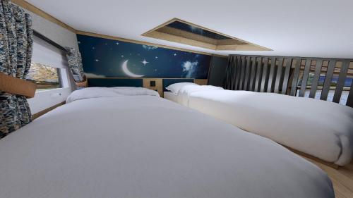 a row of beds in a room with a moon and stars at Billing Aquadrome Holiday Park in Great Billing