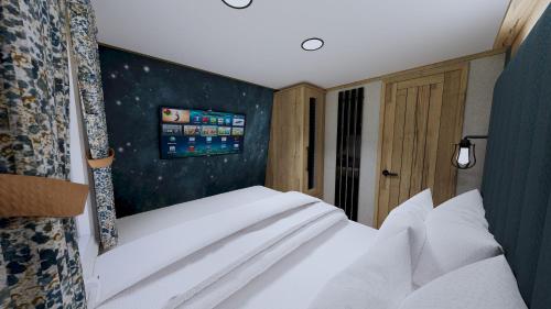 a bedroom with a white bed in a room with stars at Billing Aquadrome Holiday Park in Great Billing