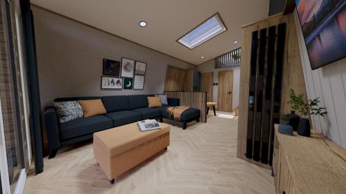 a living room with a blue couch and a tv at Billing Aquadrome Holiday Park in Great Billing