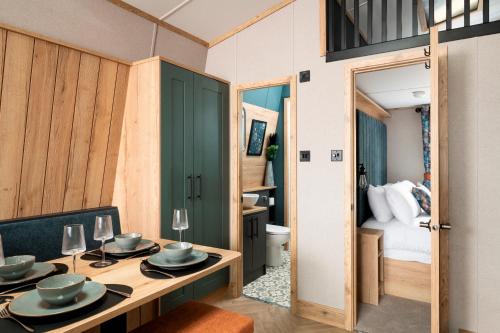 a room with a dining table and a bedroom at Billing Aquadrome Holiday Park in Great Billing