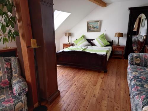 a bedroom with a bed with green pillows on it at Pension Espenhof 