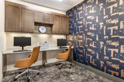 an office with two chairs and a desk with two monitors at Hilton Garden Inn Montgomery - EastChase in Montgomery