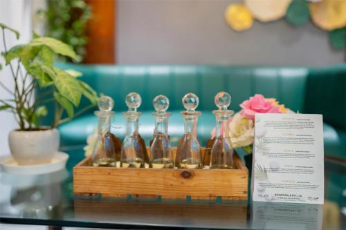a wooden crate with four glass bottles on a table at Radisson Blu Hotel Ranchi in Rānchī